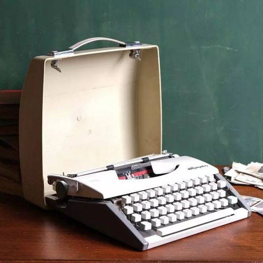 Vintage Olympia brand typewriter with bag.