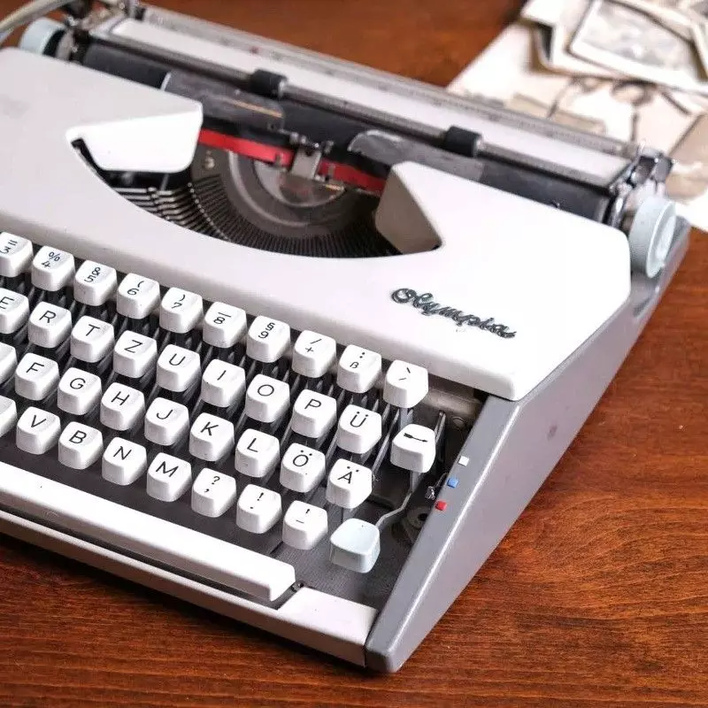 Vintage Olympia brand typewriter with bag.